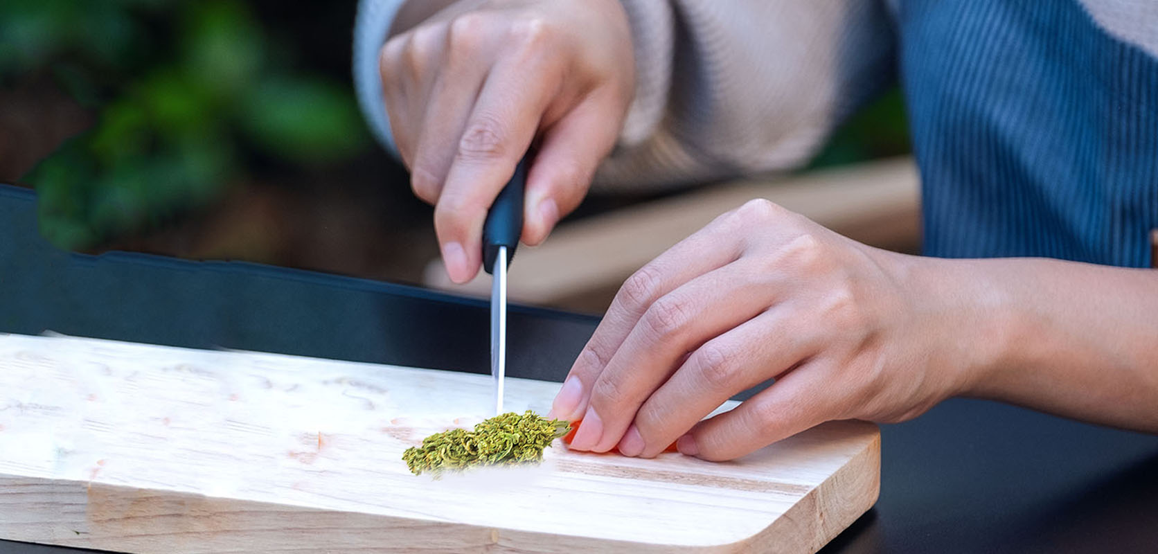 woman cutting weed with a knife because she is without a grinder. weed online canada. order cannabis online. buy weed online.