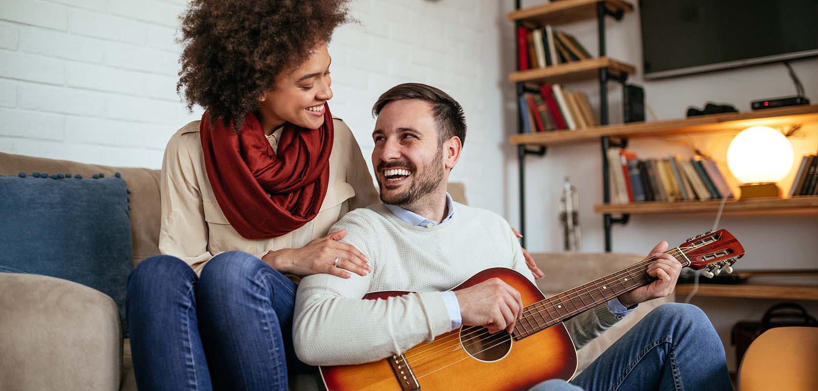 happy man playing guitar for happy female partner. buy purple haze online from BC. purchase weed online in canada.