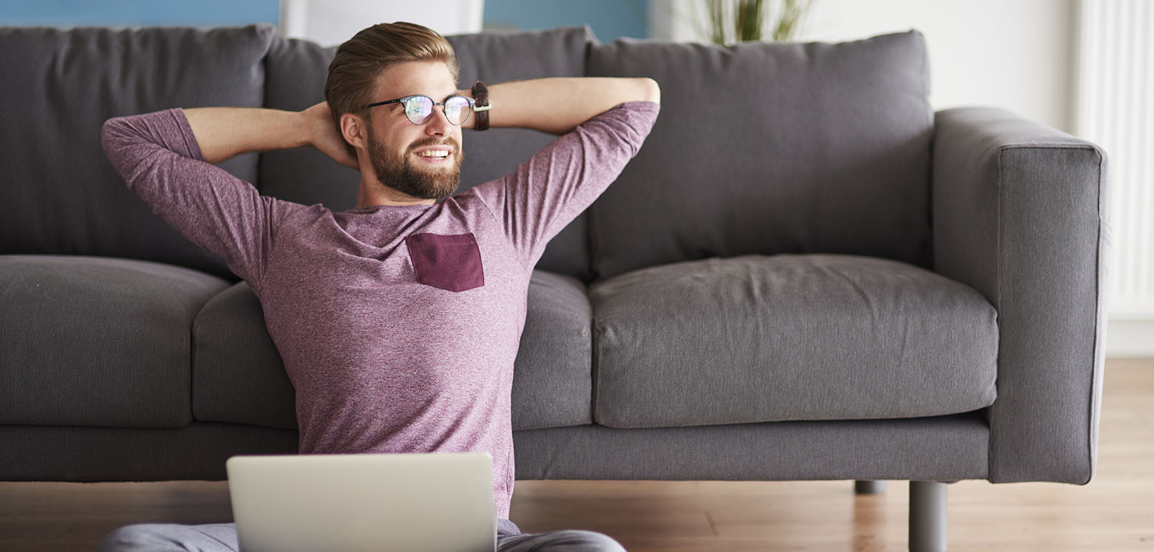 Man relaxing while working from home after smoking purple haze weed he bought online from a mail order marijuana weed shop.