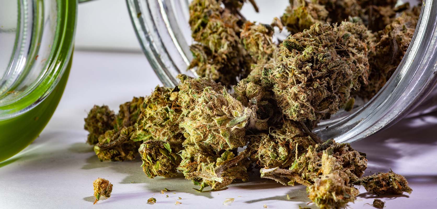 Pop Tarts Strain cannabis popcorn buds spilling out of a glass jar. buy online weeds. best online dispensary canada. mail order marijuana.