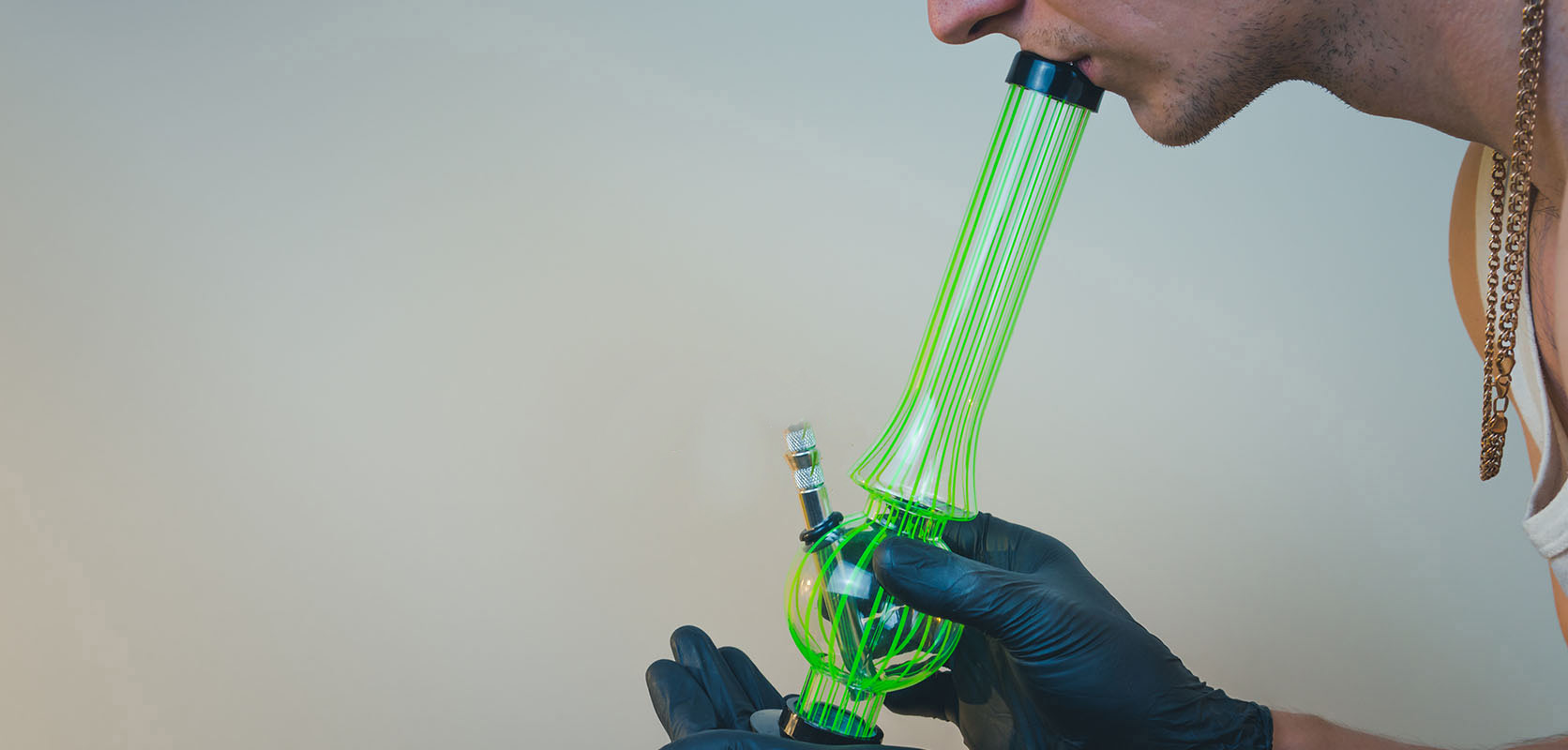 Man using a dab rig to smoke shatter. Buy shatter online, THC concentrates, supreme thc cartridges at online dispensary canada.
