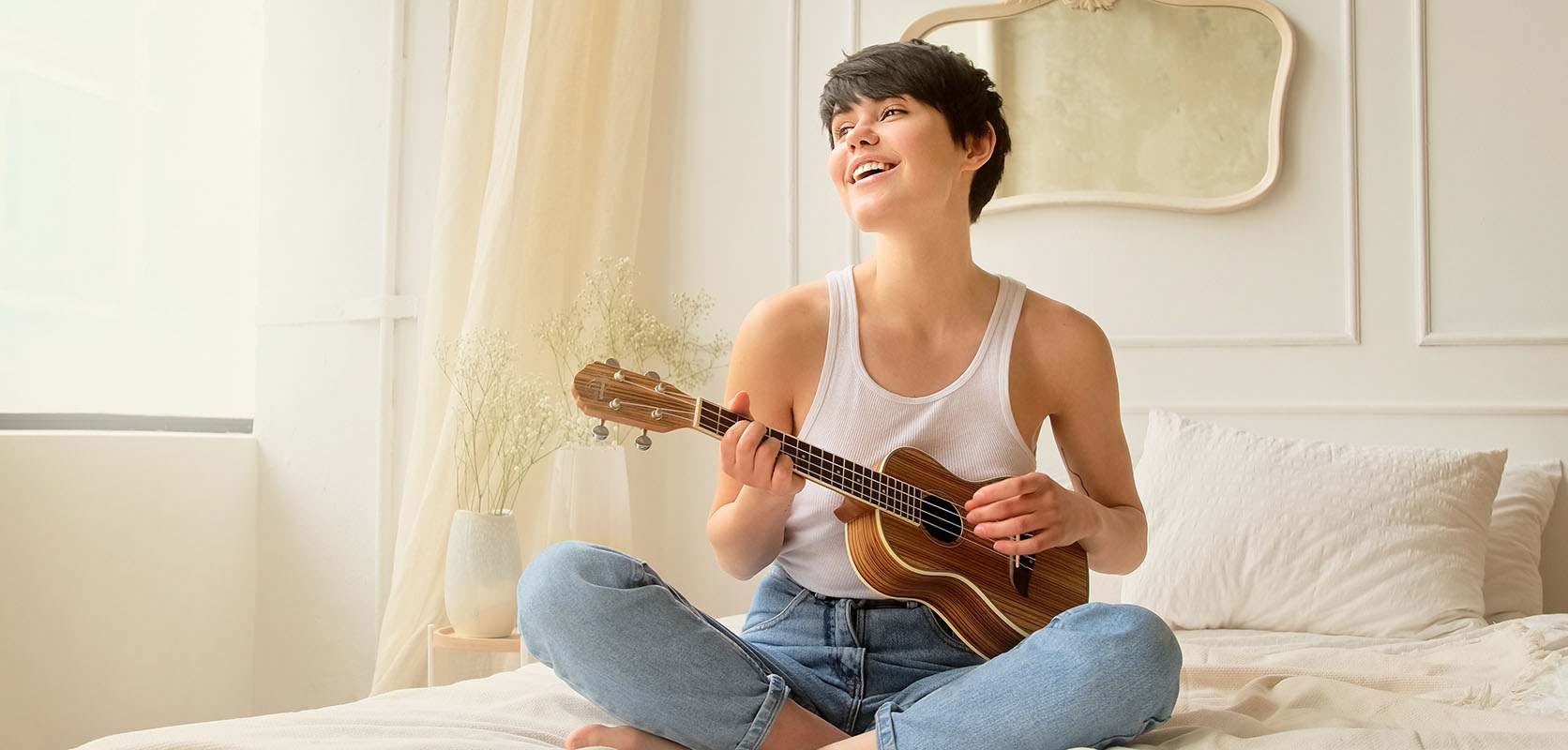 woman playing guitar on her bed after buying weed online from low price bud online dispensary and mail order marijuana weed shop.