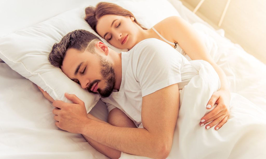Couple sleeping after smoking the best indica strain in Canada