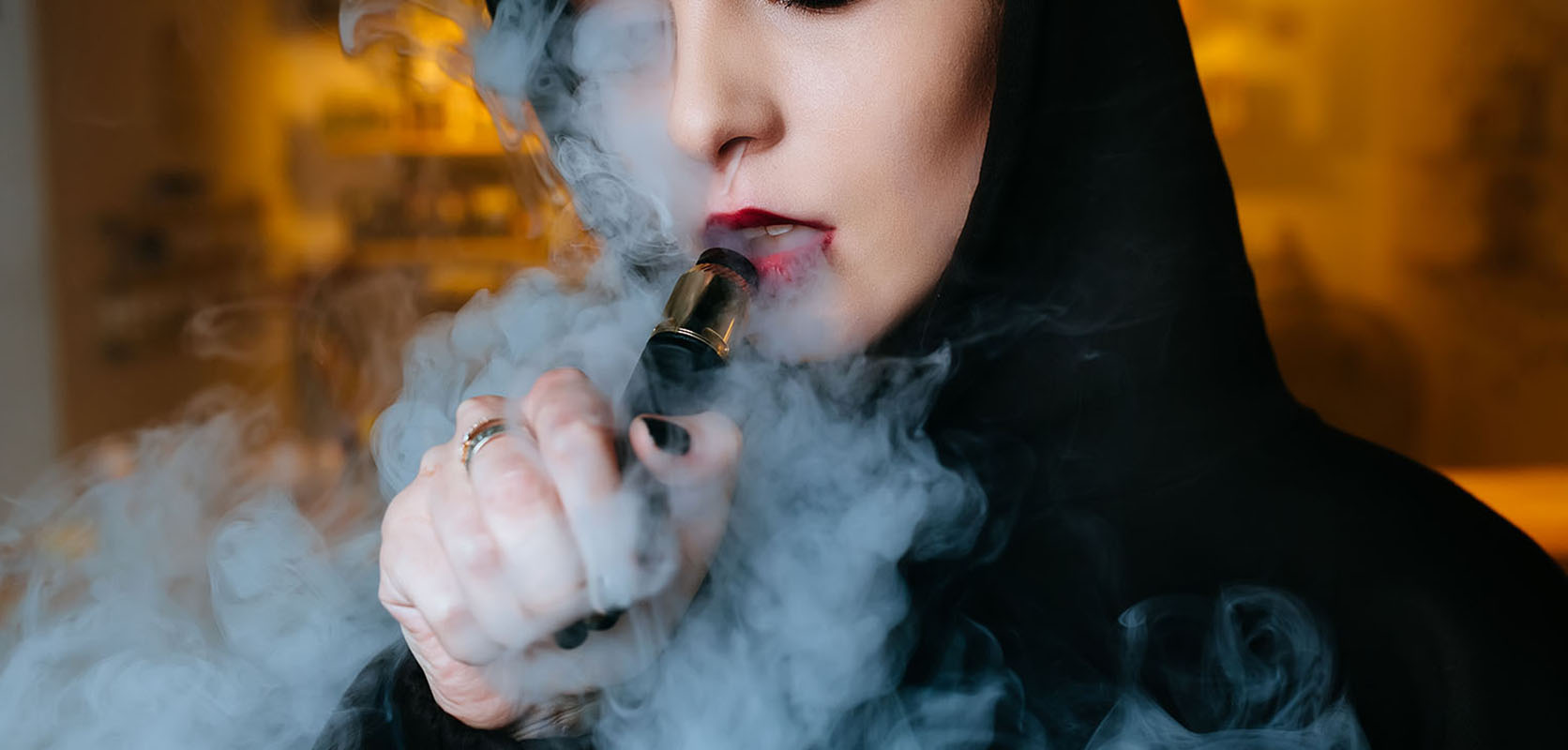 Woman vaping cannabis concentrate wax using a disposable vape pen. Buy shatter online, THC concentrates, supreme thc cartridges at online dispensary canada.