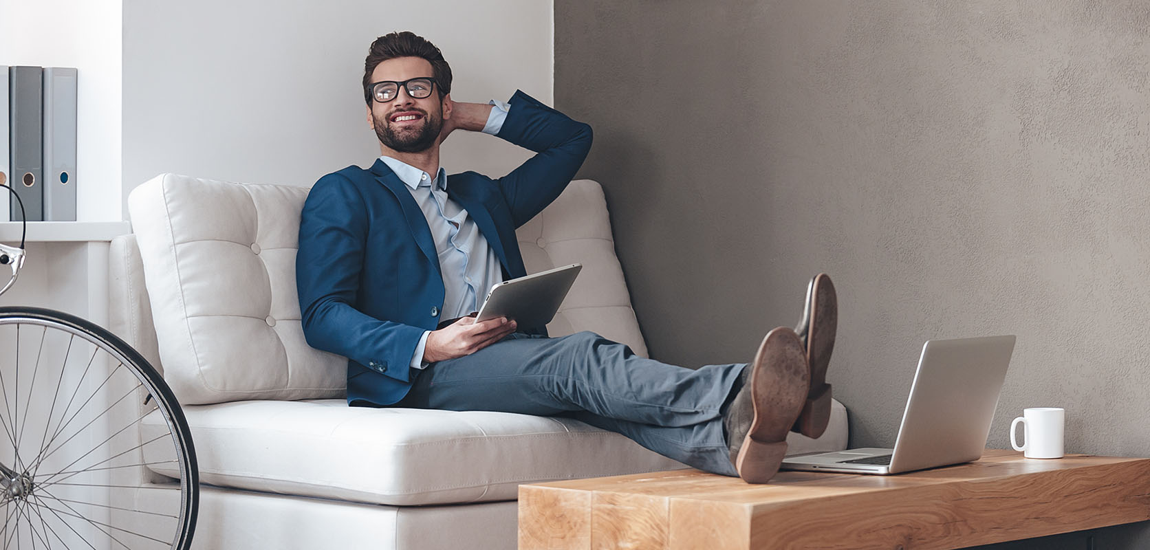 Relaxed business man working on laptop after buying weed online from Low Price Bud online dispensary in Canada to buy weed online.