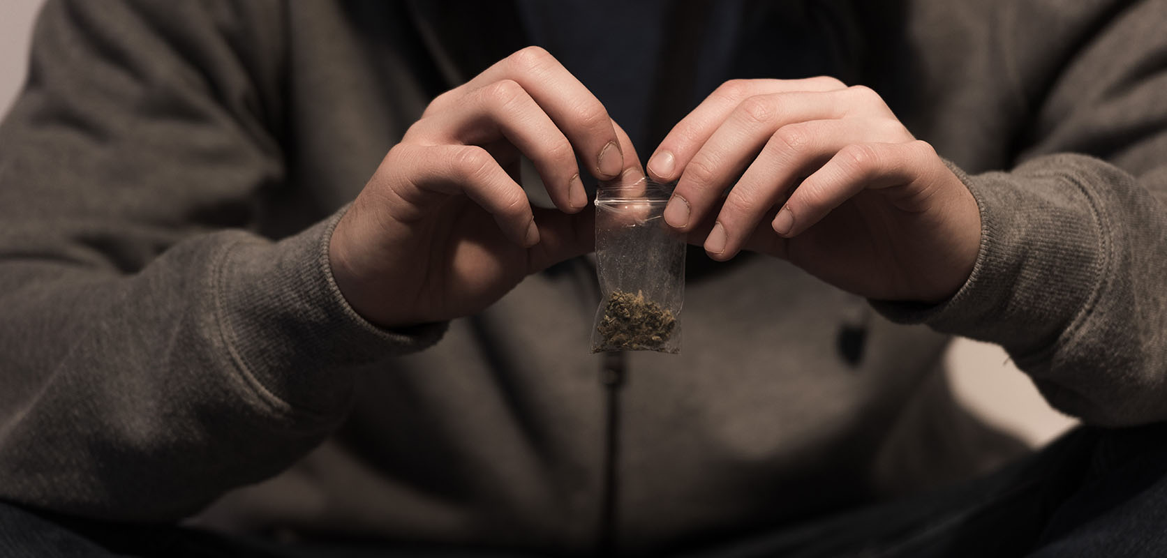 Man storing weed in a small plastic baggie. weed online canada. order cannabis online. buy weed online.