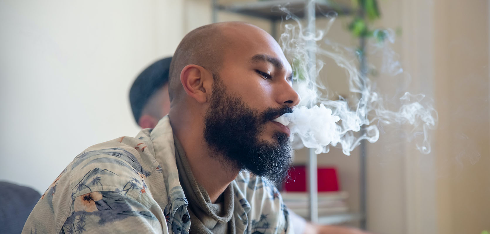 Man exhaling smoke. weed dispensary to buy cheapweed online in Canada. Shatter. buy online weeds.