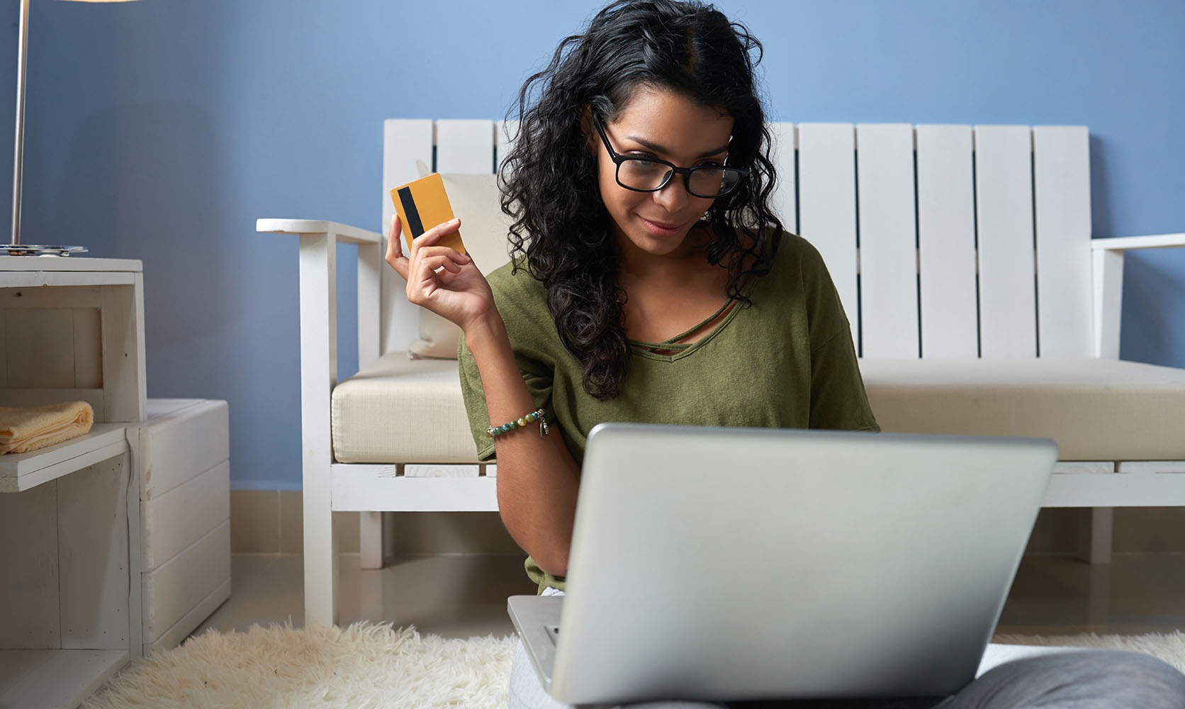 Woman with credit card on a laptop ready to order weed online from a mail order marijuana weed store and online dispensary.
