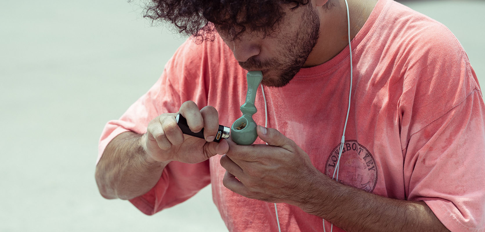 Man using a pipe to smoke crumble weed cannabis concentrate bought online in Canada at Low Price Bud weed dispensary for mail order marijuana.